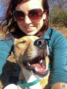 woman with smiling dog in lap